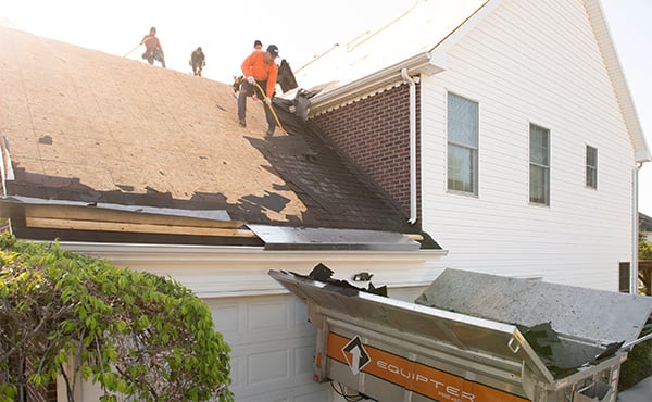 A roofing crew tearing off a roof using the Equipter 4000