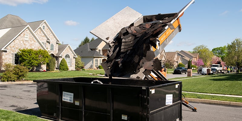 The Equipter 4000 depositing trash into a roll-off dumpster