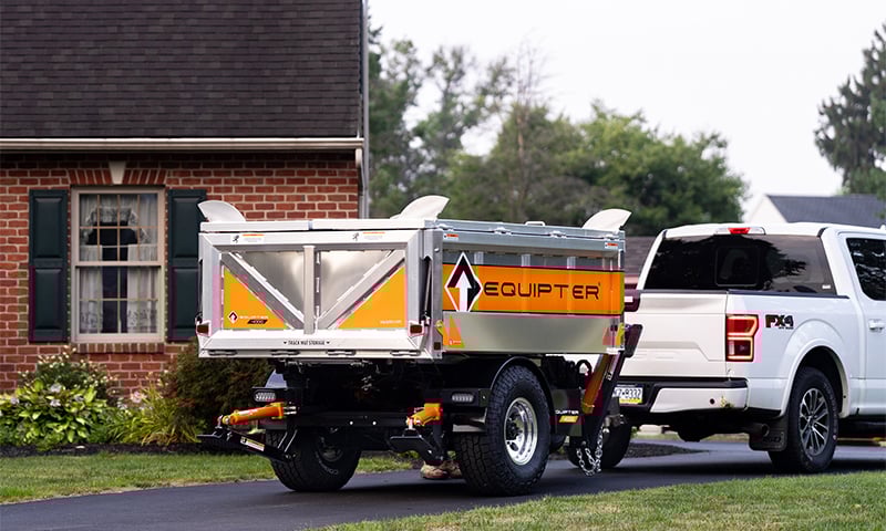 A work truck towing the self-propelled Equipter 4000 trailer