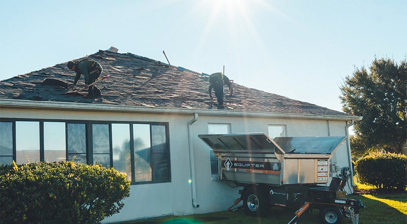 A roofing crew with an Equipter 4000 on site to catch debris