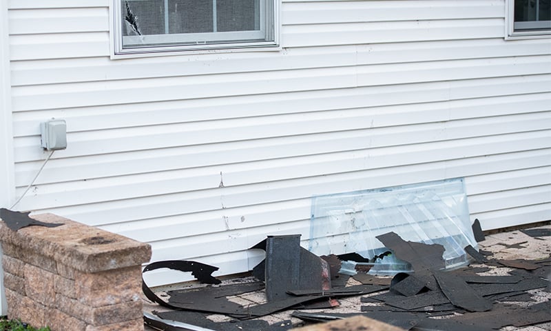 Falling shingles cause property damage on a roofing installation