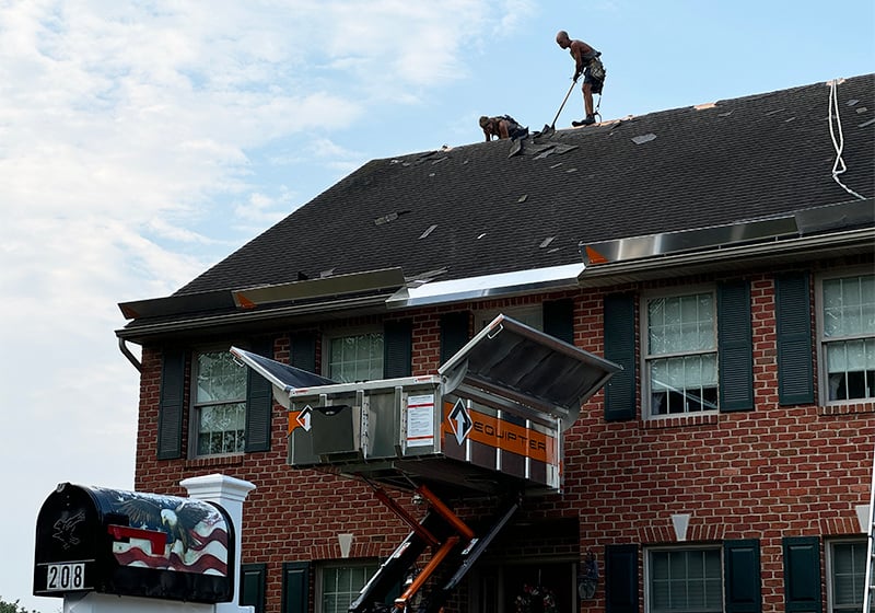 A crew start work on a roof tear-off with an Equipter 4000