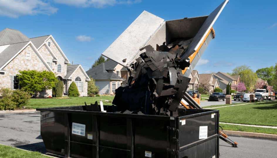 Equipter 4000 dumping debris into a rollaway dumpster