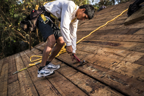 roofing employee on the roof