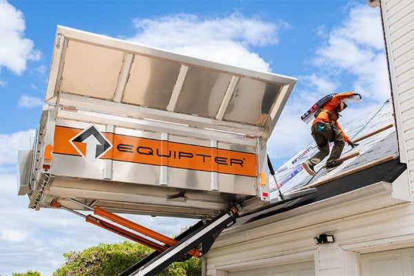 Roofer moving supplies from an Equipter 4000