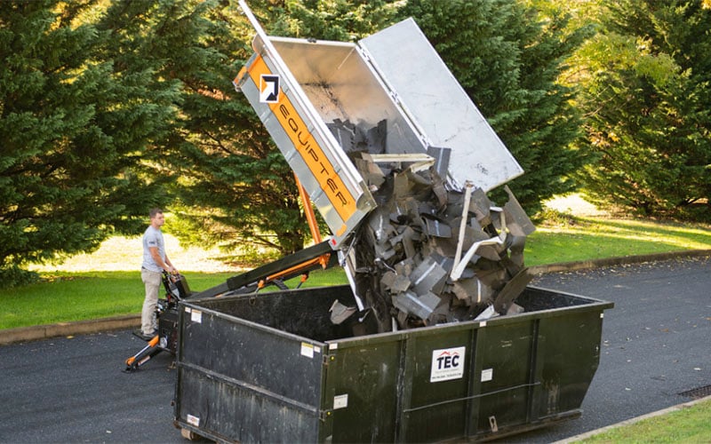 Equipter 4000 dumping debris into dumpster