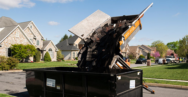 The Equipter 4000 depositing debris into a rolloff dumpster